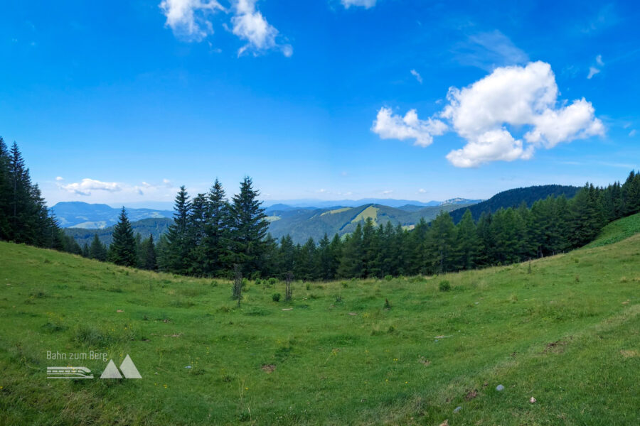 Berg- und Kogelpanorama, links der Schöckl, etwa in der Mitte mit dem Wiesenhang der Buchkogel, rechts davon erhebt sich die Rote Wand. Foto: Alice Frischherz